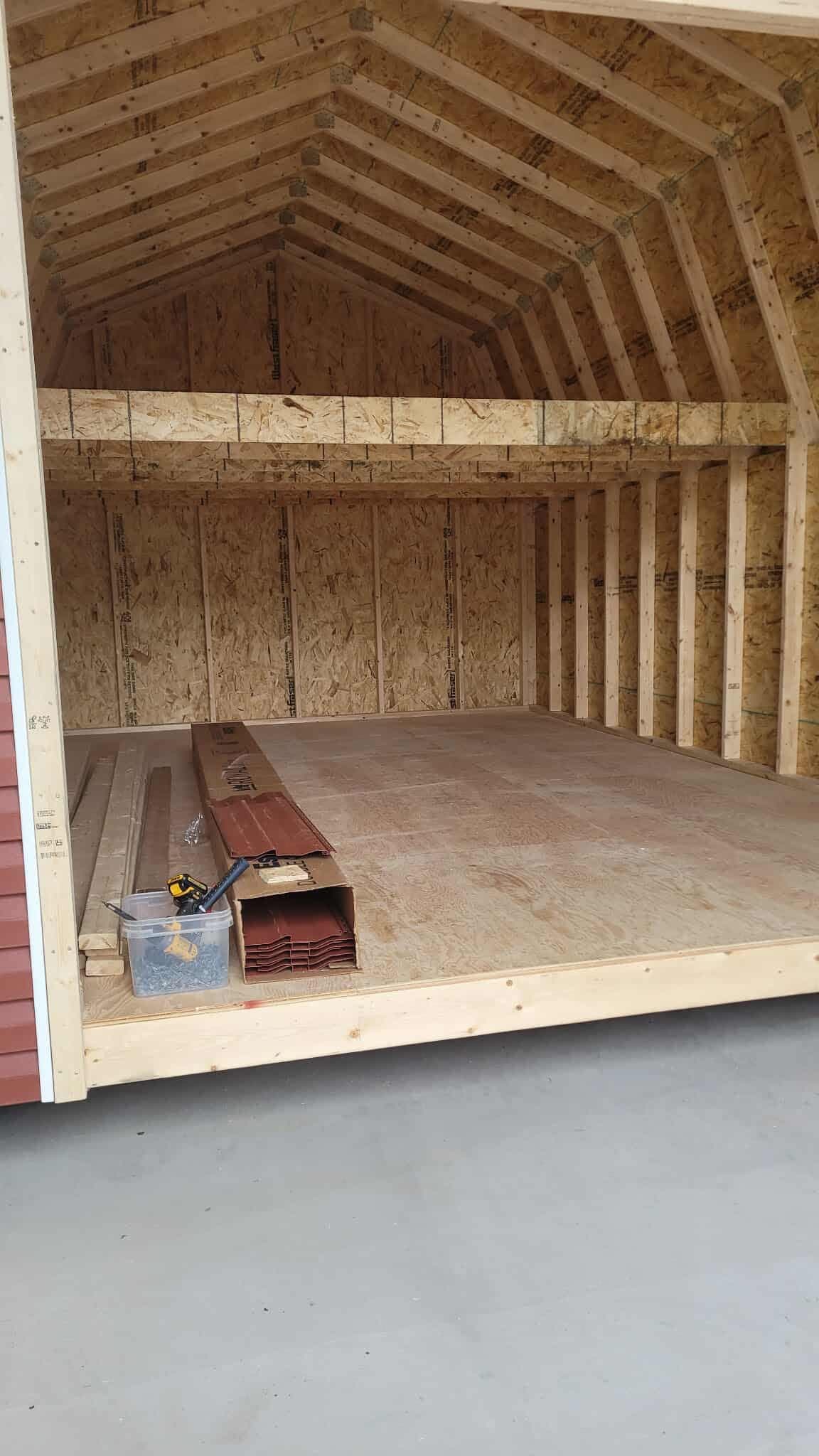 Interior framing with wall studs, roof trusses and a plywood floor deck